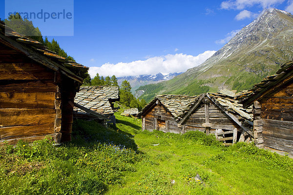 Louché  Switzerland  Europe  canton Valais  nature reserve Val d'Hérens  Alp  nightmare huts  stone roofs  view  valley  mountains  clouds Kanton Wallis