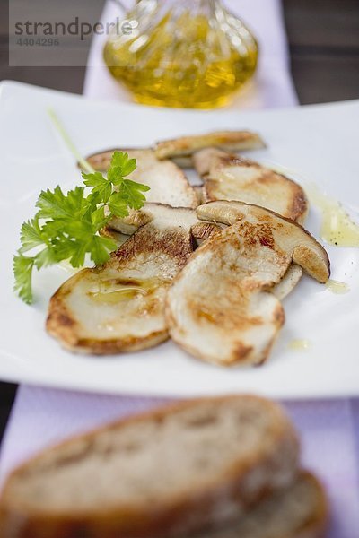 Fried cep slices with parsley  olive oil and bread