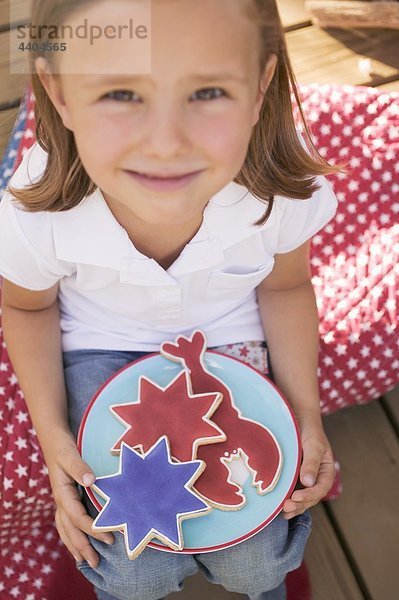 Kleine Mädchen halten eine Platte von Cookies (4. Juli  USA)