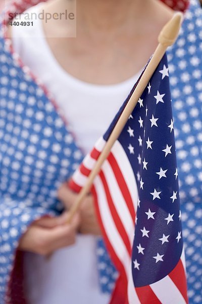 Frau hält amerikanische Flagge (4. Juli  USA)