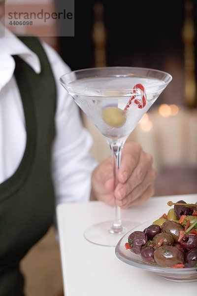 Frau mit Glas Martini mit olive