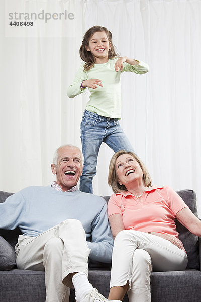 Enkelin (6-7) tanzt und Großeltern genießen  lächeln
