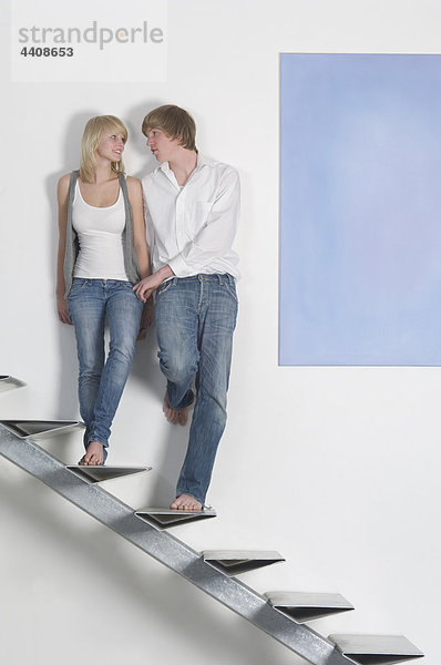 Teenager-Paar auf der Treppe von Angesicht zu Angesicht stehend