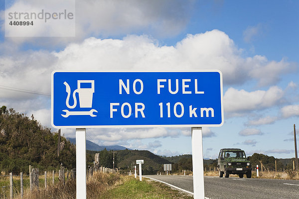 Neuseeland  Südinsel  Westküste  Informationsschild in Nahaufnahme mit Auto auf der Straße im Hintergrund
