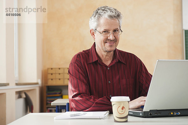 Senior Mann mit Laptop  Portrait  lächelnd