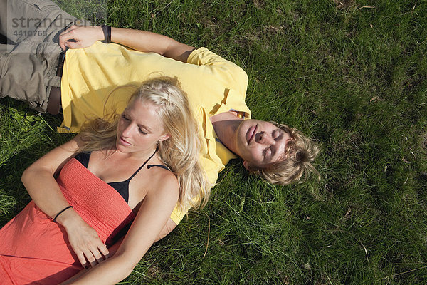 Germany  Dortmund  Young couple resting on grass