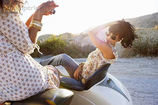 Frauen auf dem Motorrad beim Fotografieren