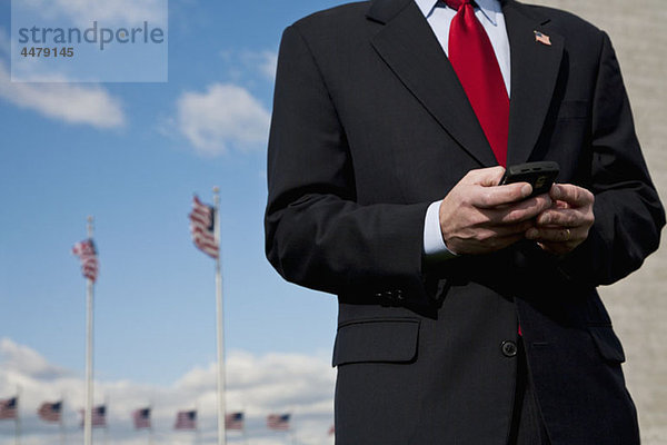 Ein Mann Textnachrichten  amerikanische Flaggen im Hintergrund