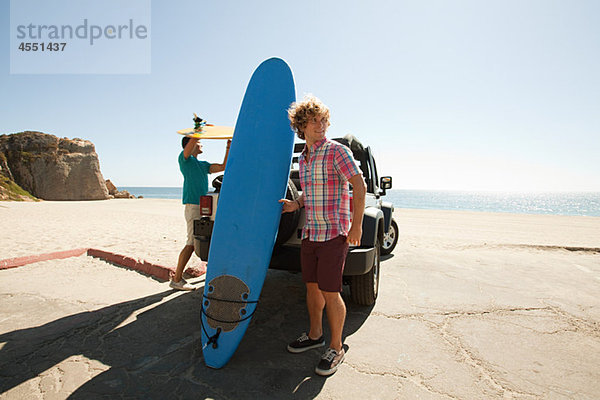 Zwei junge Männer mit Surfbrettern