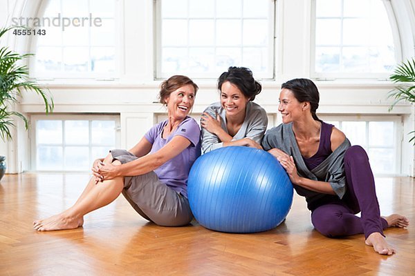 Drei Frauen mit Fitness-Ball im Fitness-Studio