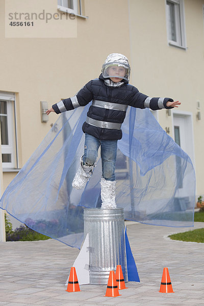 Junge als Raumfahrer verkleidet  versucht zu fliegen