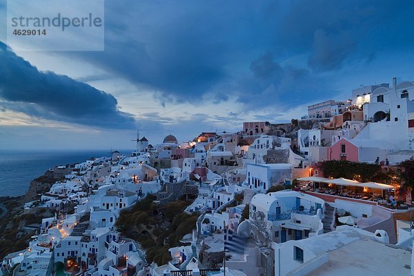 Griechenland  Kykladen  Thira  Santorini  Blick auf Oia und Windmühlen bei Sonnenuntergang