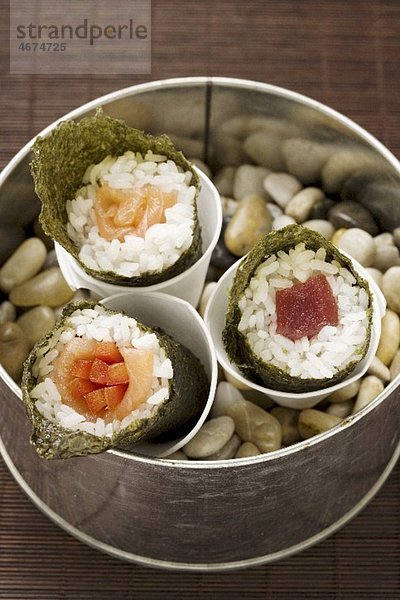 Temaki sushi with tuna  salmon and carrot sticks (Japan)