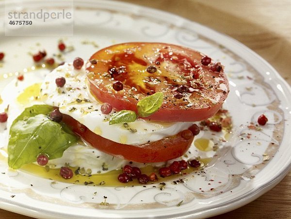 Tomaten mit Mozzarella  Basilikum  Olivenöl und rosa Pfeffer