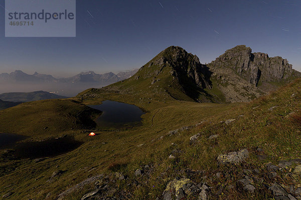 Night shot  Lake Berglimattsee with illuminated tent  Glarus Alps  Canton Glarus  Switzerland  Europe