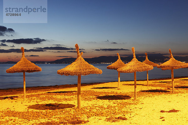 Straw umbrellas on the beach  S'Arenal  El Arenal  evening mood  Majorca  Balearic Islands  Spain  Europe