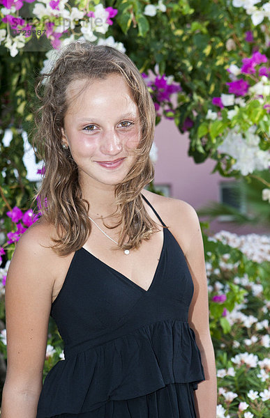 Porträt eines dreizehnjährigen Mädchens  hinten Blumen