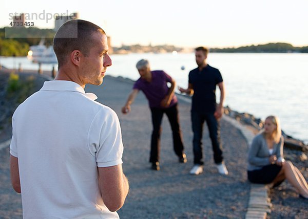 Gruppe von Freunden spielen mit Boule Meer