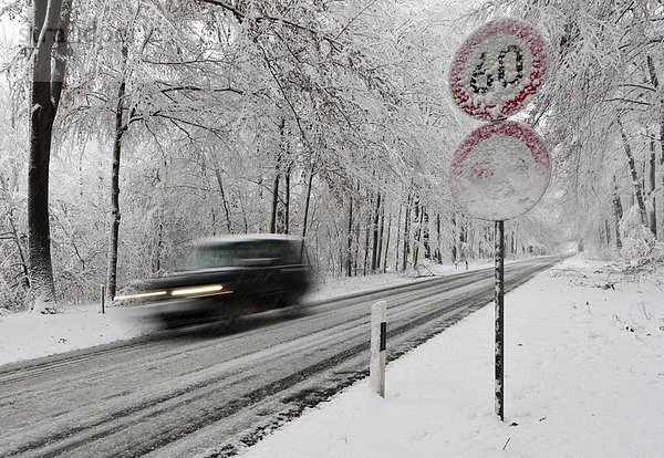 Geschwindigkeitsbegrenzung auf 60  verschneite Landstraße im Winter mit schnellem Verkehr  Hessen  Deutschland  Europa