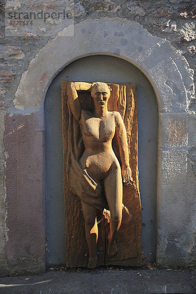 Holzskulptur eines Frauenkörpers am Zehntturm in Bischofsheim an der Rhön  Rhön-Grabfeld  Unterfranken  Bayern  Deutschland  Europa