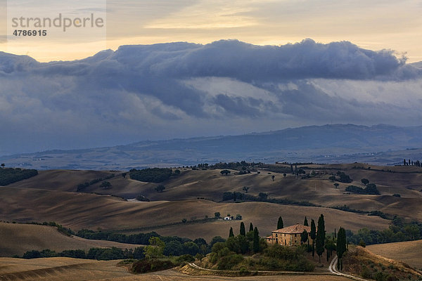 Toskanische Villa in ländlicher Umgebung  Landschaft mit dunklen Gewitterwolken am Horizont  Orciatal  Toskana  Italien Europa