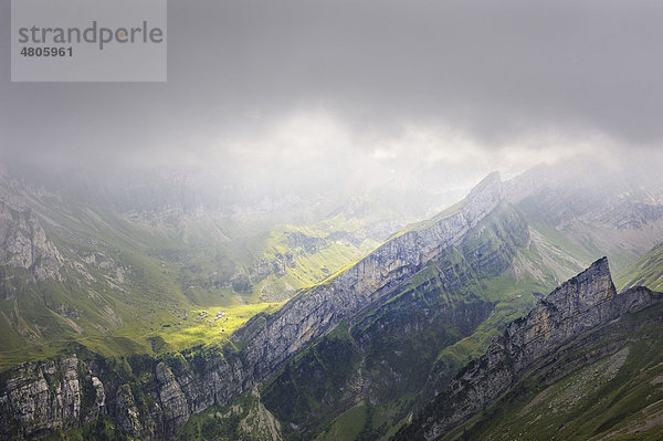 Lichtstimmung in den Appenzeller Alpen vor einem Gewitter mit der angestrahlten Alpsiedlung Meglisalp  Kanton Appenzell-Innerrhoden  Schweiz  Europa
