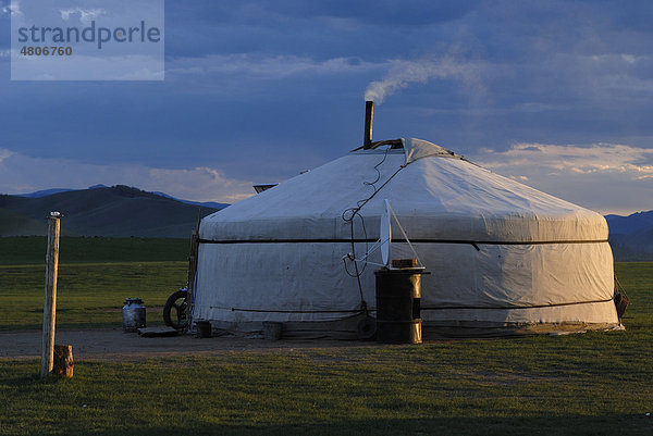 Mongolisches Ger  Jurte  Rundzelt im Abendlicht mit rauchender Esse im Grassland am Orkhon Wasserfall  Orkhon Khürkhree  Kharkhorin  Övörkhangai Aimak  Mongolei  Asien