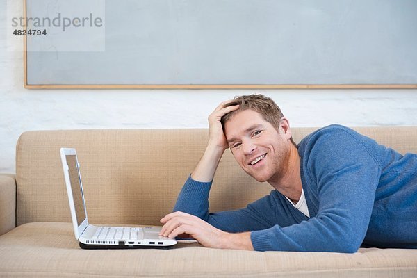 Mittlerer Erwachsener Mann mit Laptop  lächelnd  Portrait