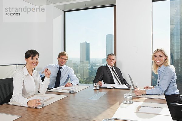 Deutschland  Frankfurt  Geschäftsleute im Konferenzraum  lächelnd  Portrait
