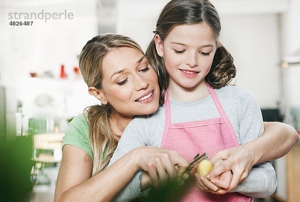 Deutschland    Mutter und Tochter schälen Kartoffeln