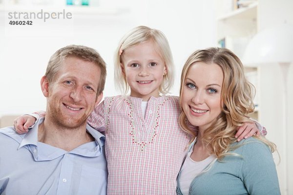 Deutschland  Bayern  München  Tochter und Eltern zu Hause  lächelnd  Portrait