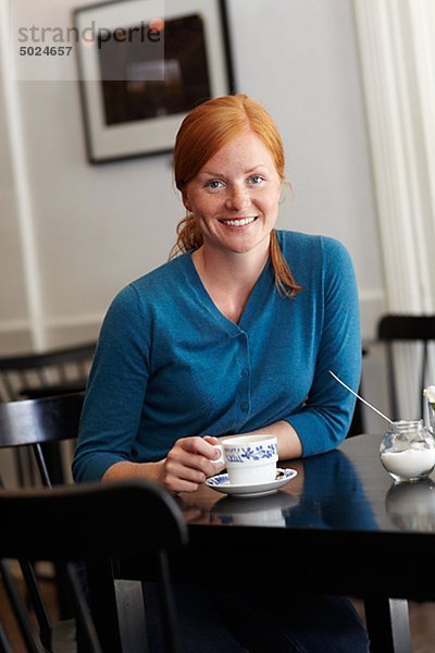 Portrait of young smiling Woman in cafe