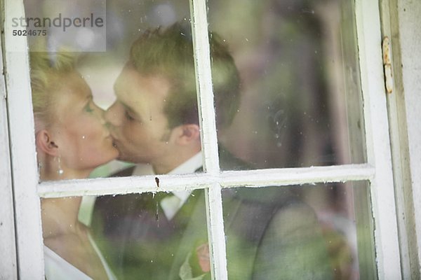 Paar küssen hinter Fenster