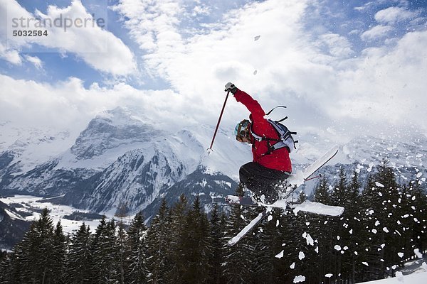 Skier jumping  mountain in background