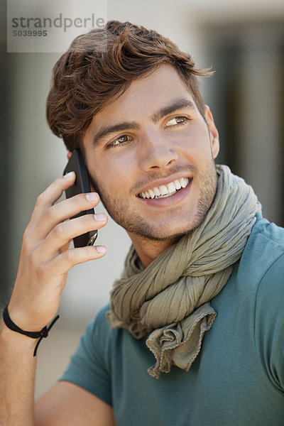 Junger Mann spricht auf dem Handy