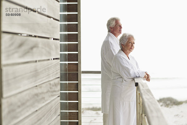 Seniorenpaar auf dem Balkon stehend