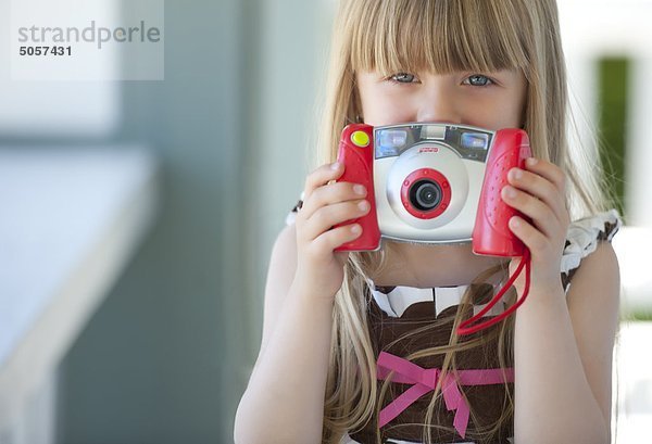 Girl holding Toy Kamera