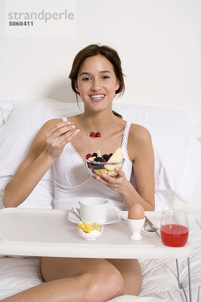 Frau dem Frühstück in ihrem Bett
