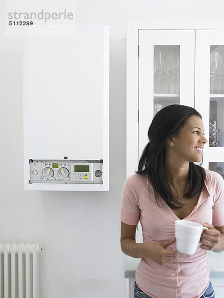 Frau bei einer Tasse Kaffee in der Küche