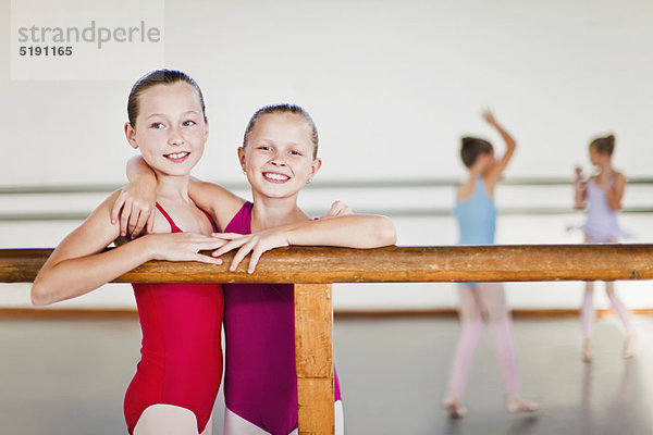 Balletttänzer umarmen sich an der Stange