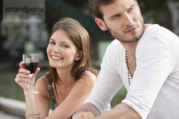 Frau trinkt Rotwein und lächelt  Paris  Ile-de-France  Frankreich