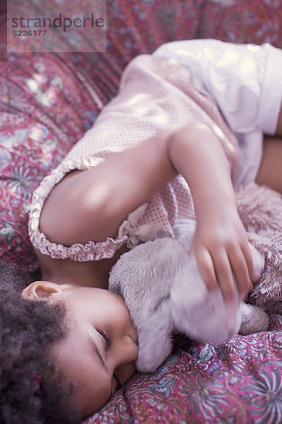 Kleines Mädchen beim Mittagsschlaf mit Stofftier
