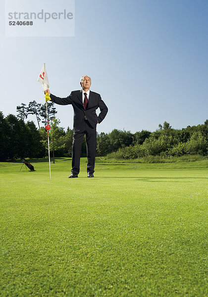 Älterer Manager auf Golfplatz