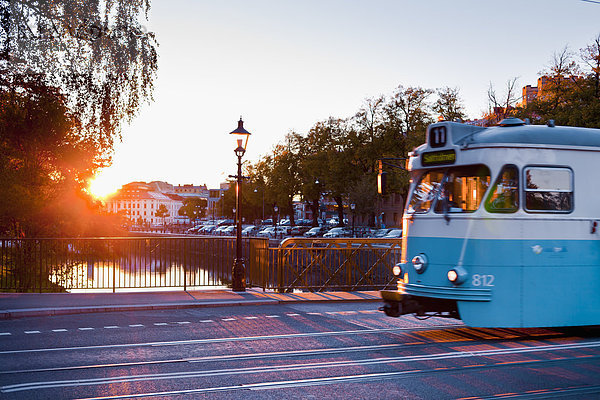 Straßenbahn auf Straße bei Sonnenuntergang