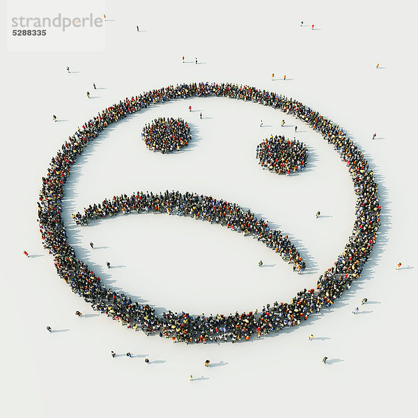 Luftbild einer Menschenmenge in Form eines traurigen Smileys
