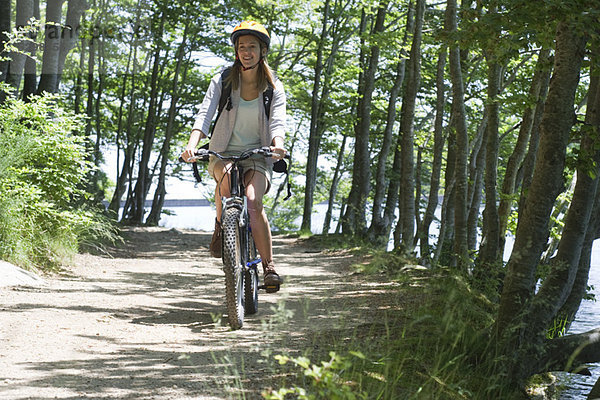 Frau fährt Fahrrad im Wald