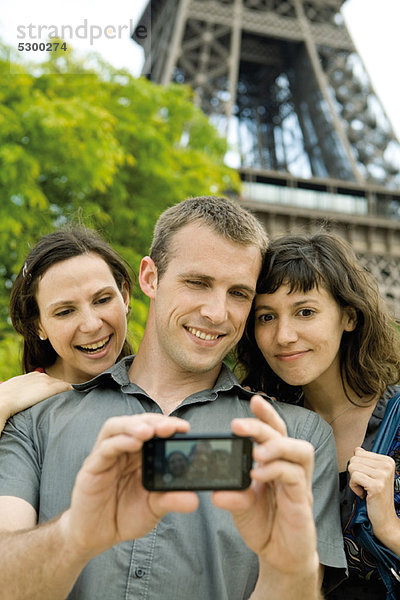 Freunde posieren für Bild vor dem Eiffelturm  Paris  Frankreich