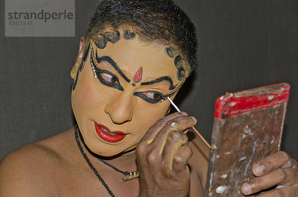 Das Make-up für die Kathakali-Figur Nakrathundi wird aufgetragen  Varkala  Kerala  Indien  Asien