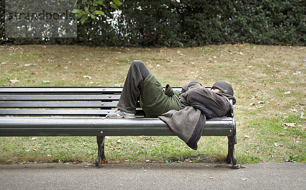 Ein Obdachloser schläft auf einer Bank im Zentrum von London  England  Großbritannien  Europa