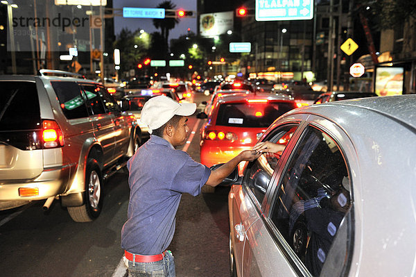 Jugendlicher  Straßenkind  putzt Autoscheiben an einer Kreuzung  um damit etwas Geld zu verdienen  Mexico City  Ciudad de Mexico  Mexiko  Mittelamerika